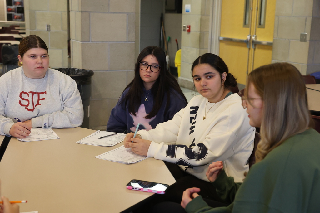 students sit at the table and listen to college student advice