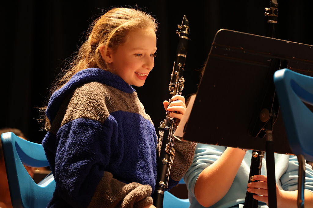 student smiles with clarinet