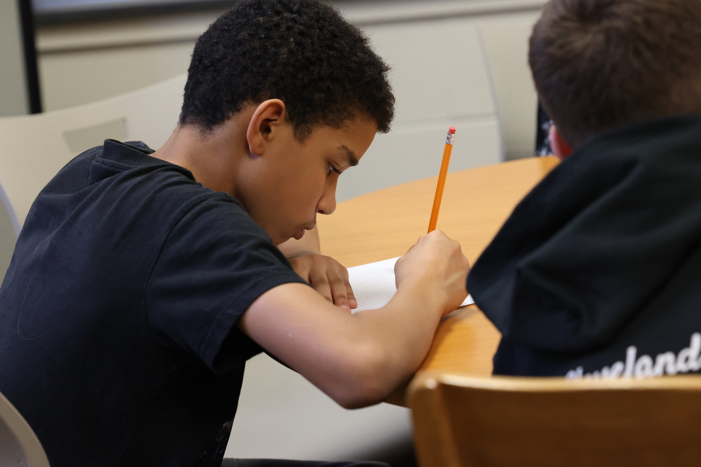 student takes note with pencil