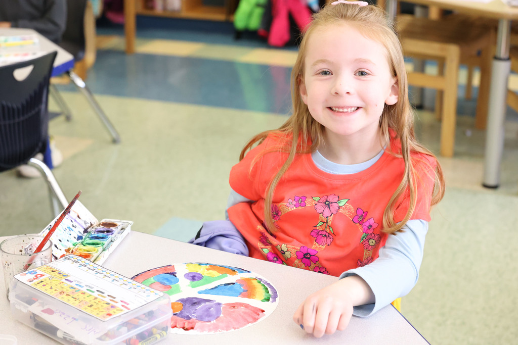 student smiles while painting