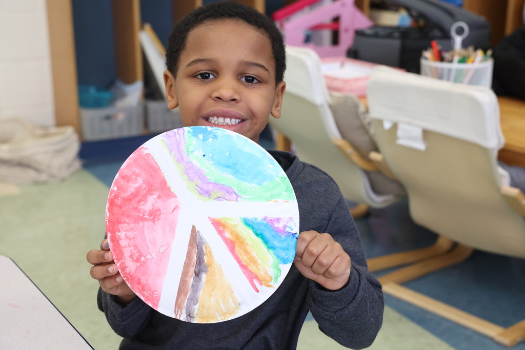 student shows off peace sign painting