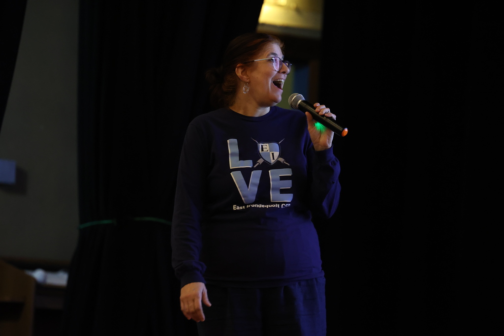 teacher smiles with mic