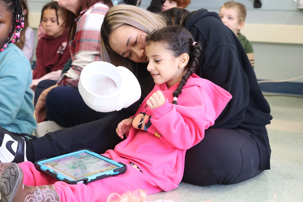 Student and teacher look at pipe
