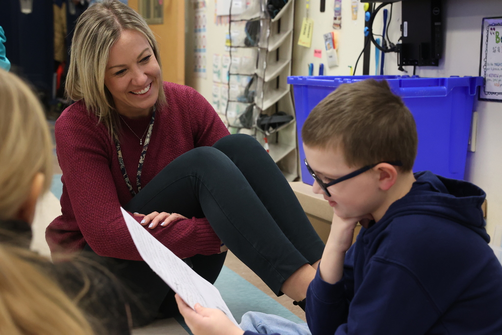 student shares work with school employee