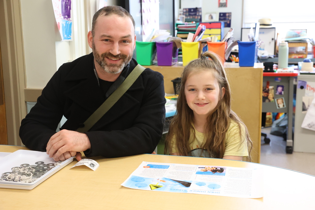 student and parent smile at the table