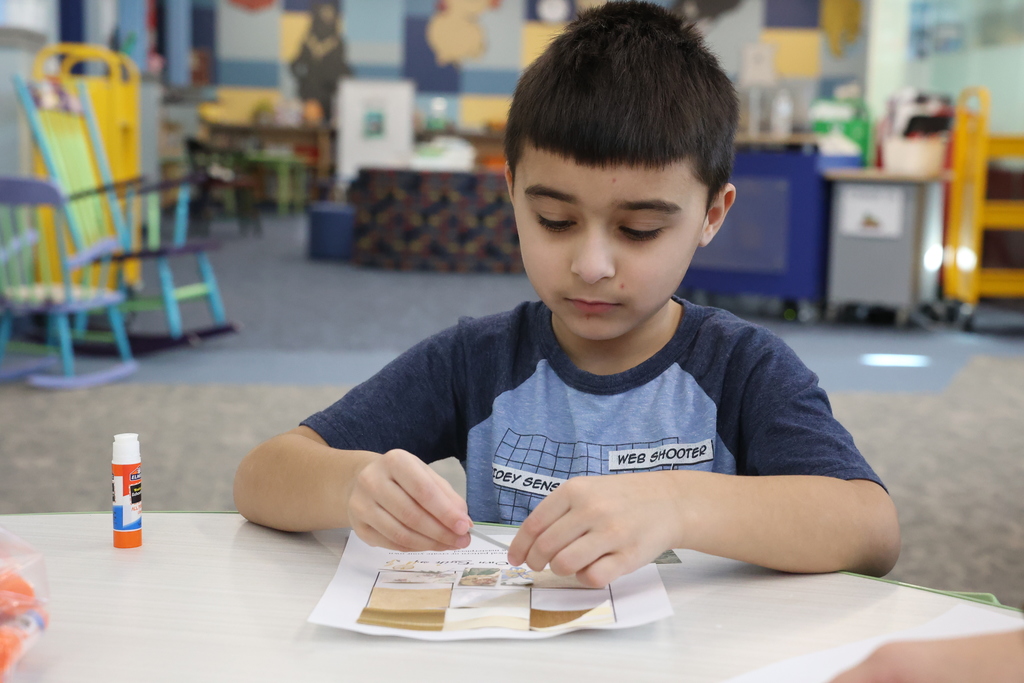 student glues paper to page