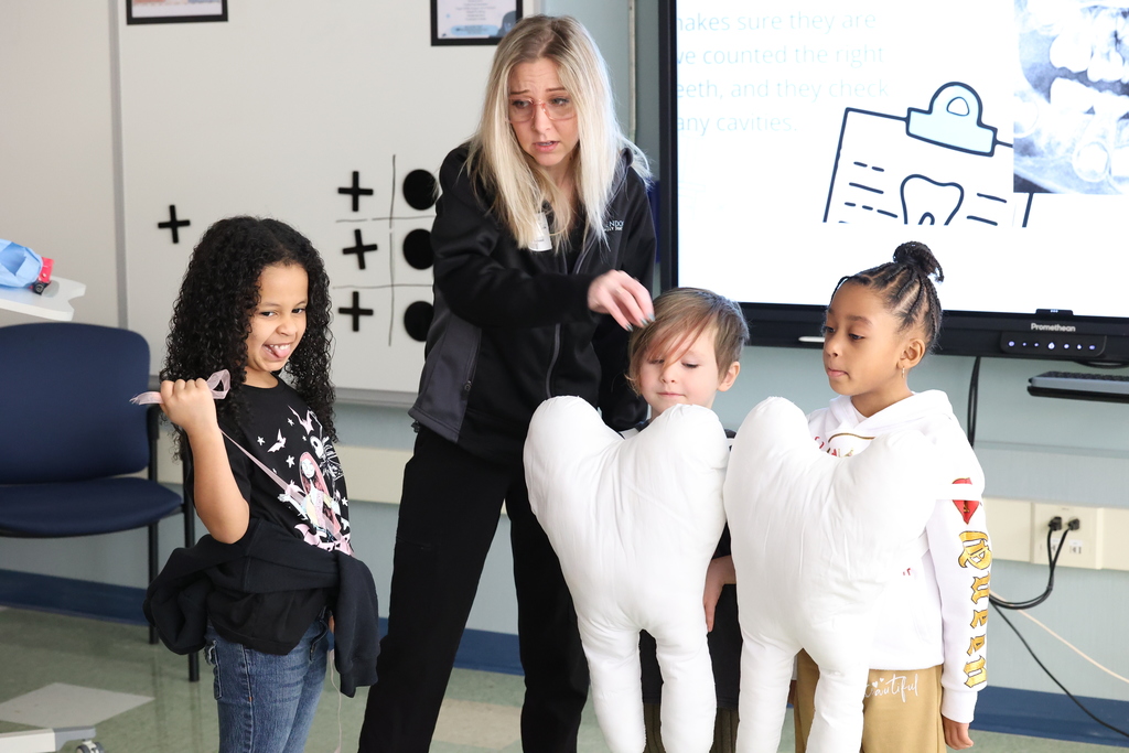 students show flossing in costume in front of classes
