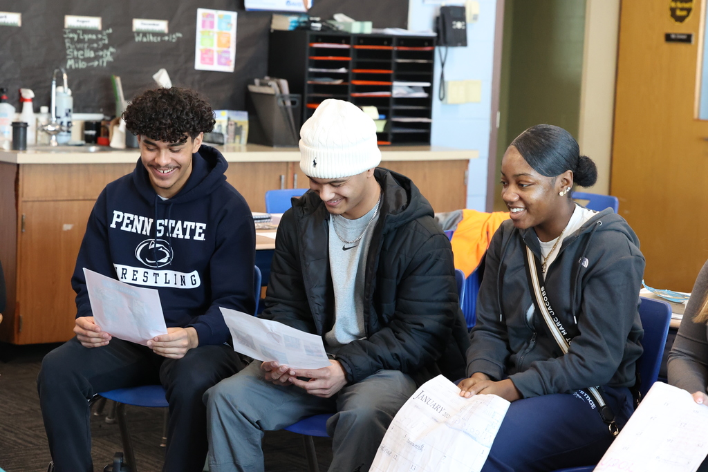 Students smile while talking to younger students