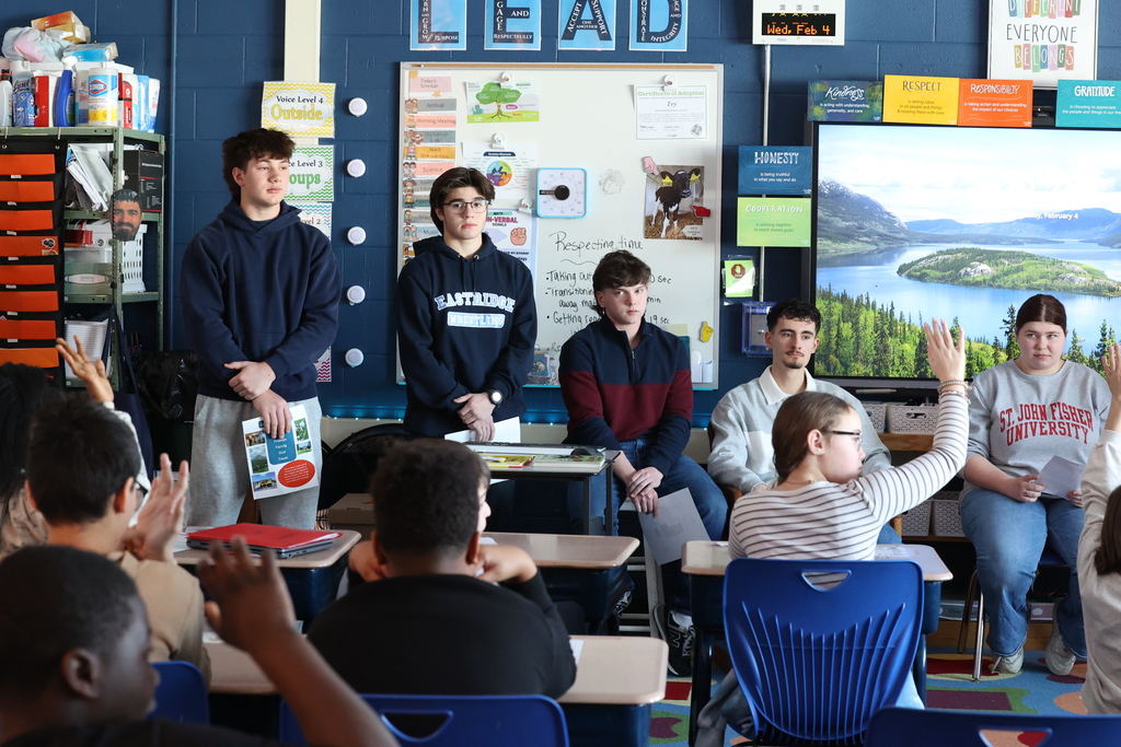 students raise hands while asking questions to seniors