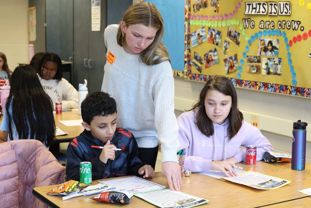 students work on worksheet with teacher