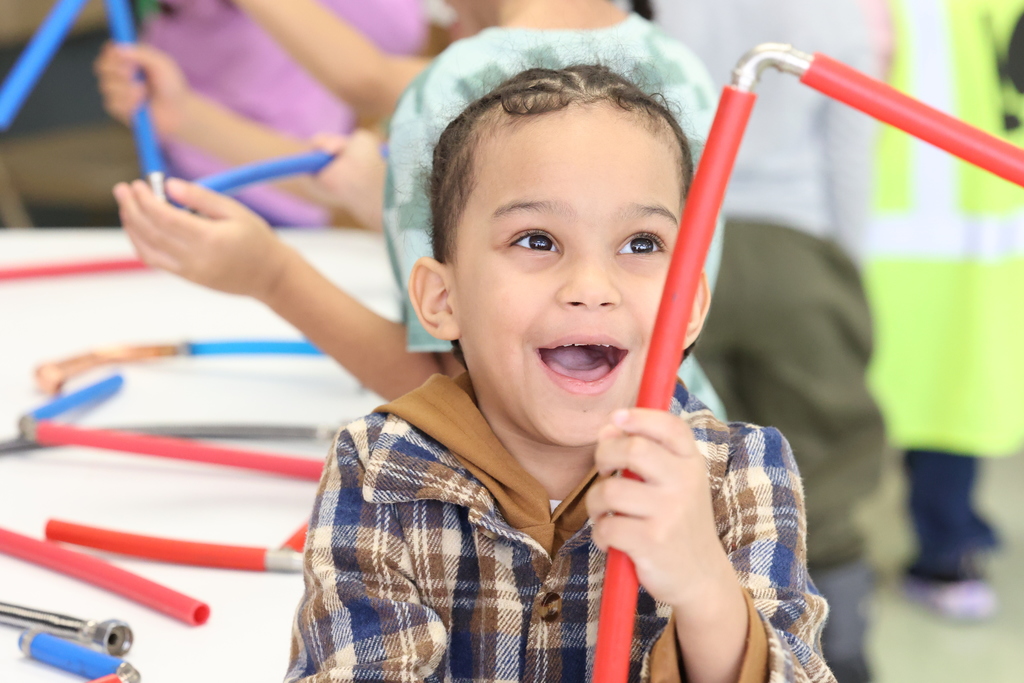 student smiles with pipes