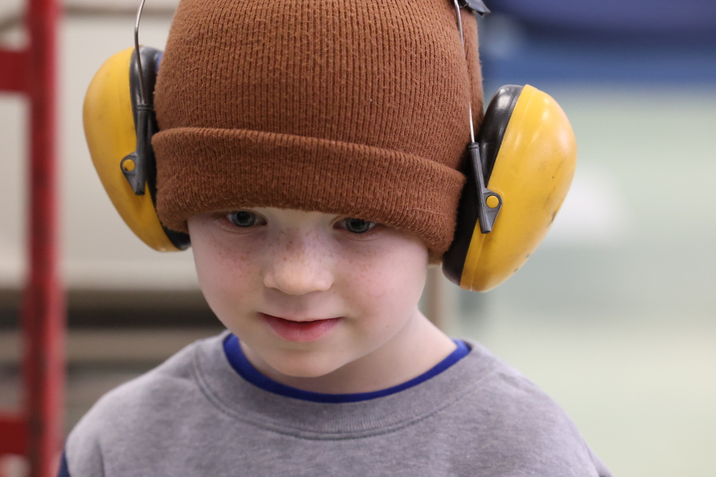 students wears ear protectors with brown hat