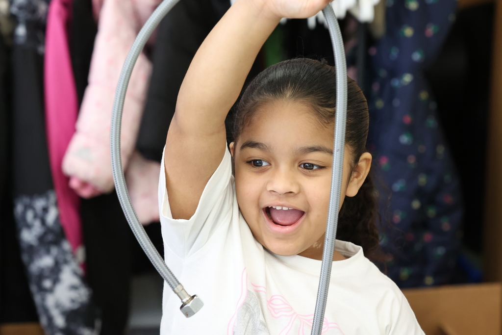 student smiles with long pipe