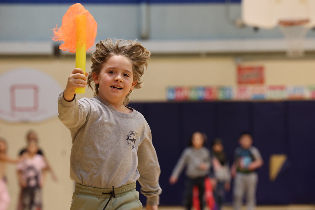 student carries fake torch