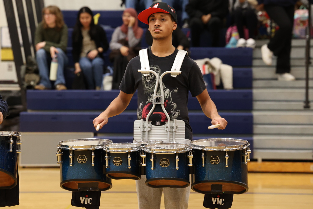 student plays drums