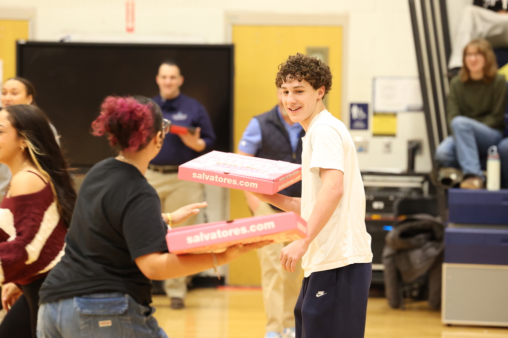 student holds pizza box