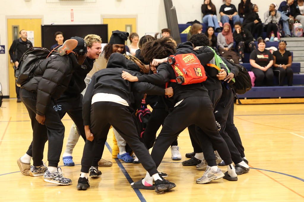 students gather for a huddle