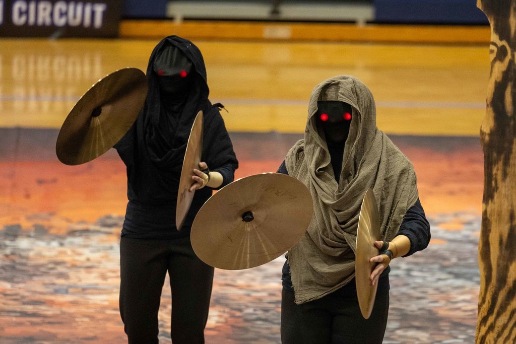 students play the cymbals dressed up 