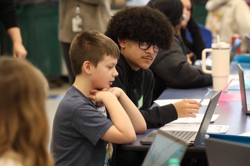 students look at computer together