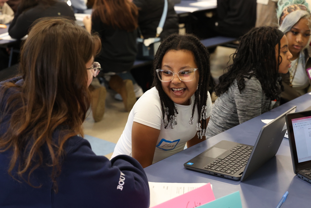 Student laughs with older student