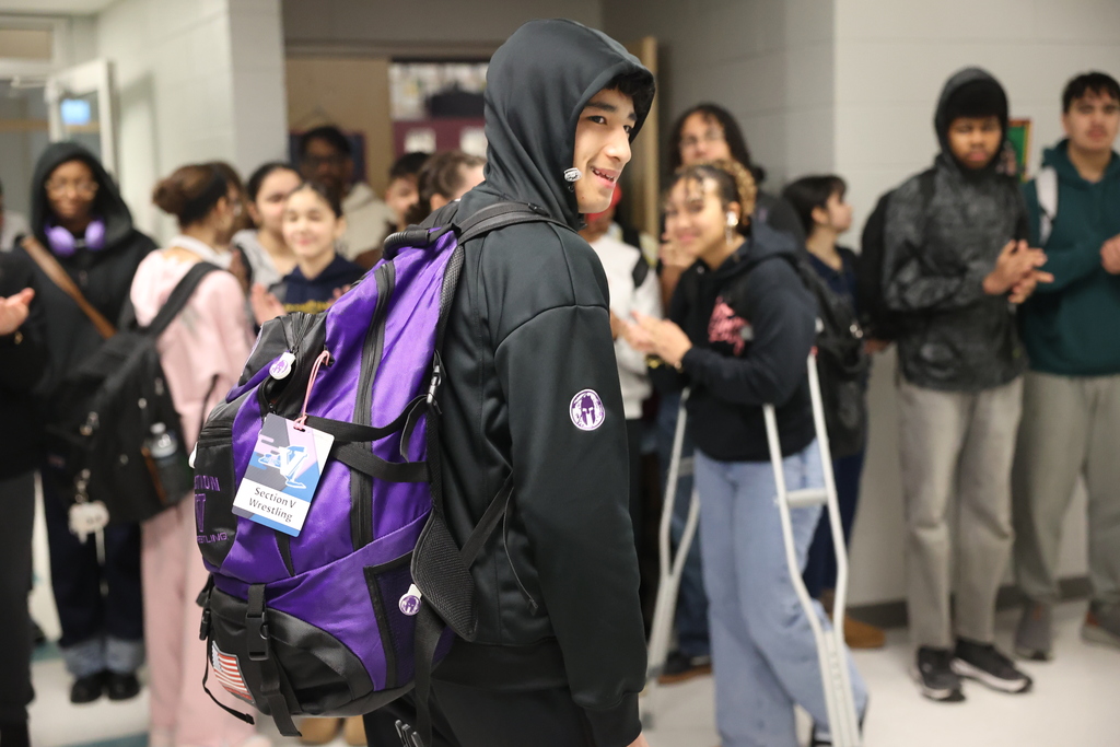 student looks at classmates cheering him on