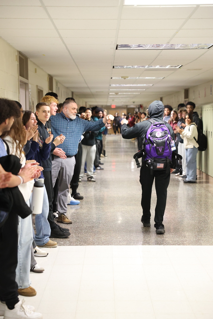 student fist bumps a teacher