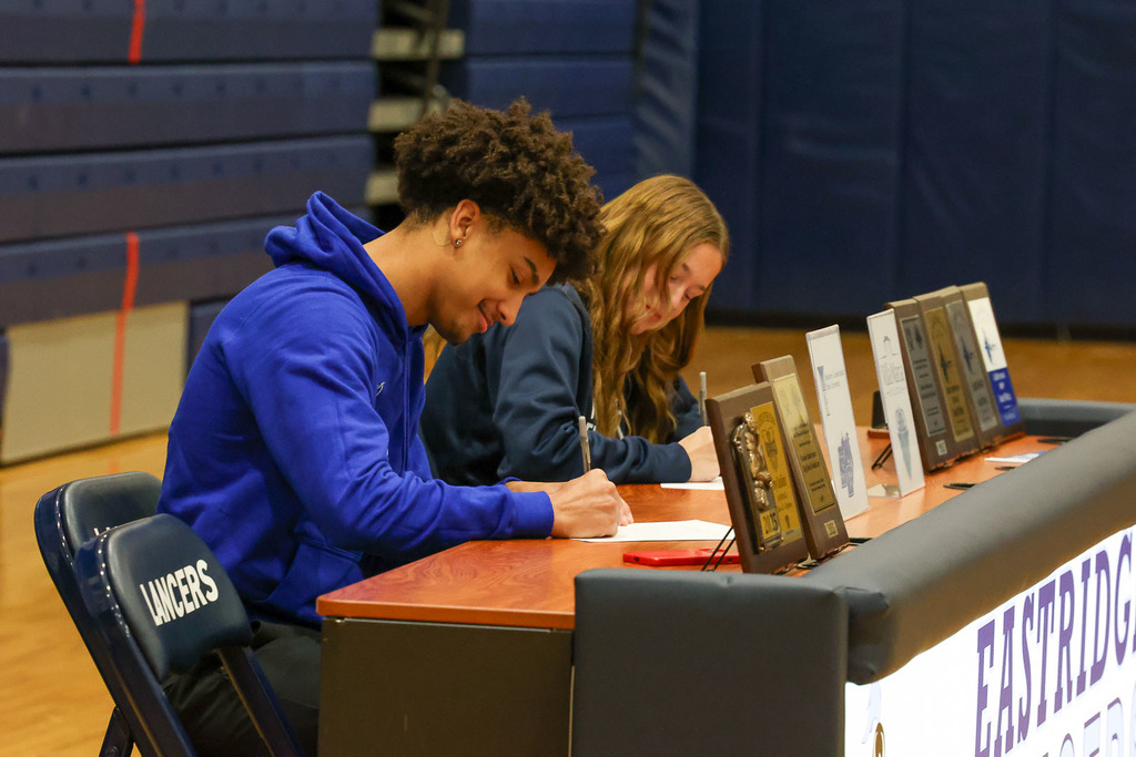 Student sign their college commitments