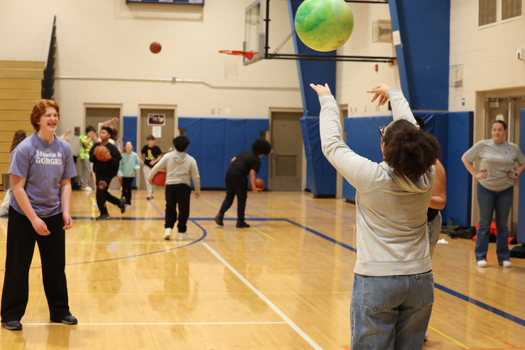 students smile and play with a ball