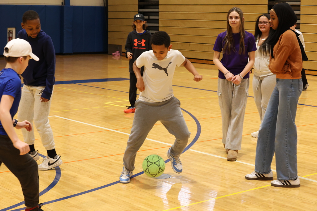 students play with a soccer ball