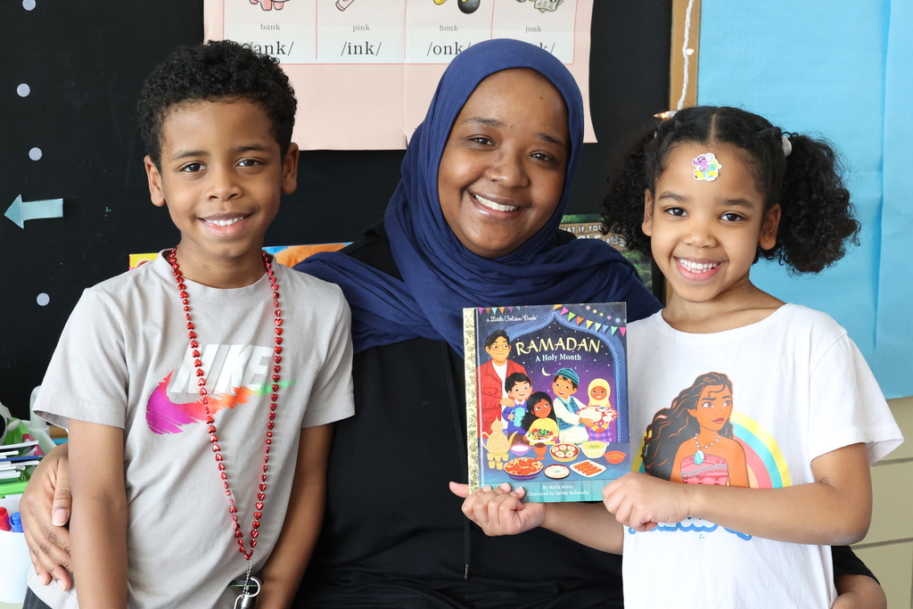 parent and kdis with ramadan book