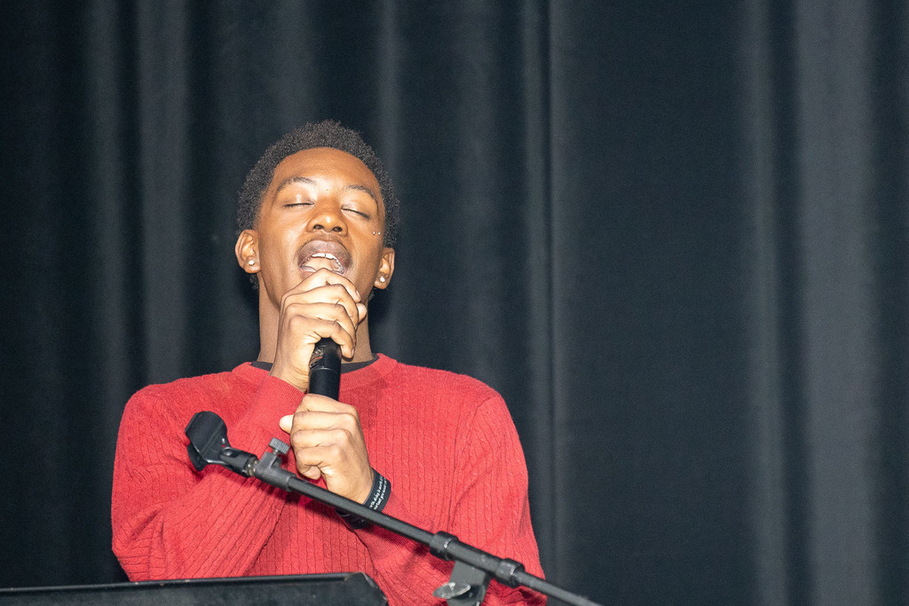 Students giving presentations and performances during the black history month celebration