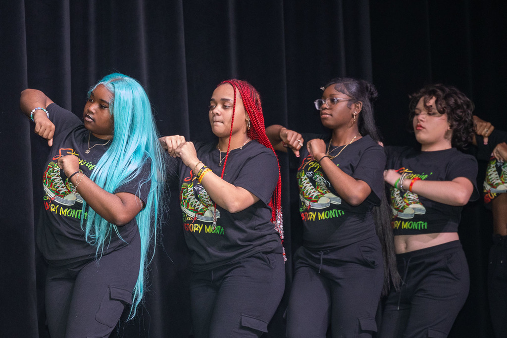 Students giving presentations and performances during the black history month celebration