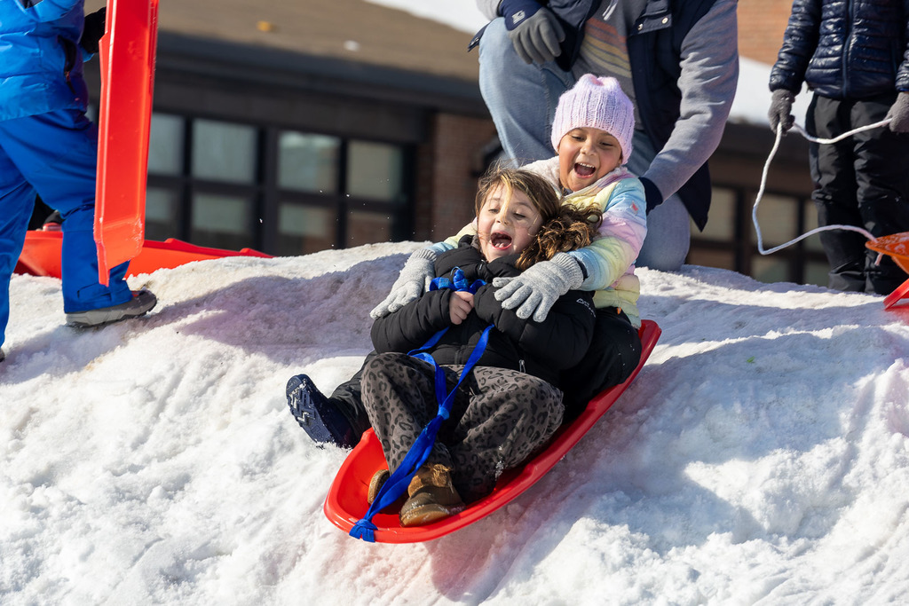 Kids playing in the snow and sledding