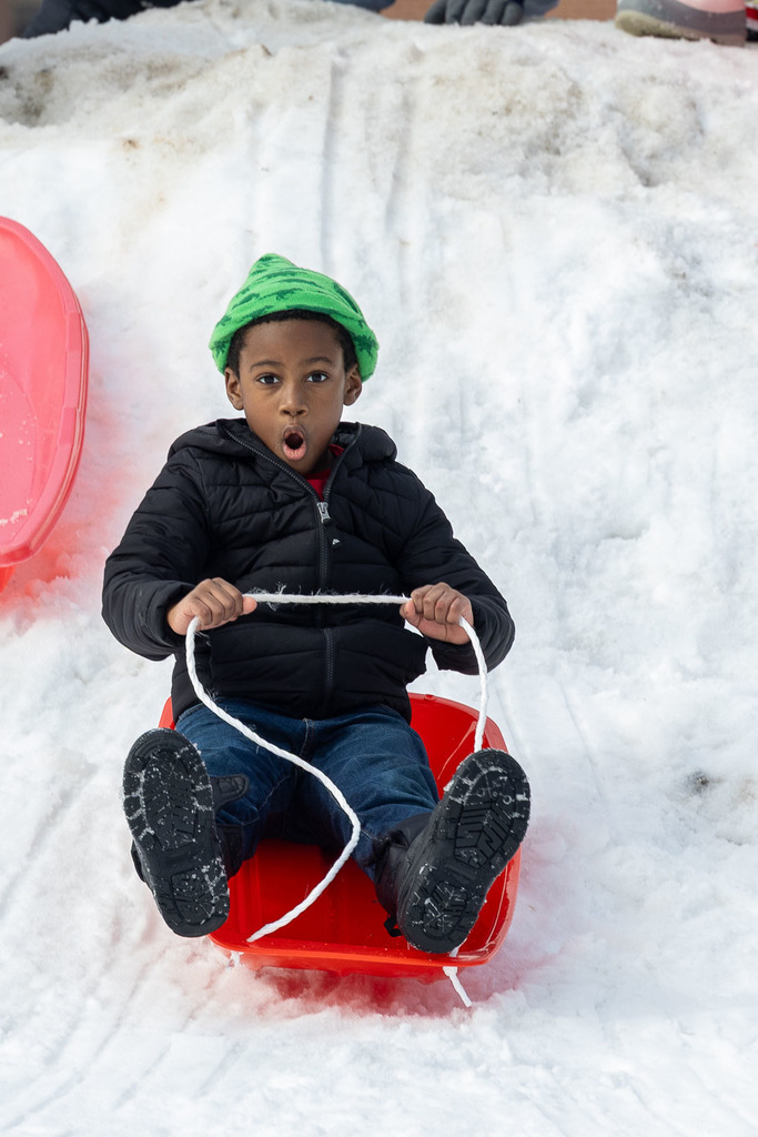 Kids playing in the snow and sledding