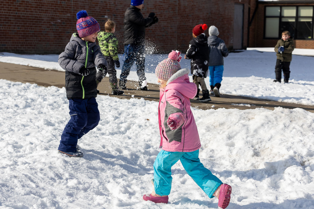 Kids playing in the snow and sledding