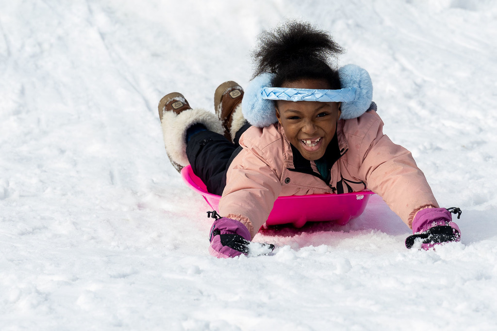 Kids playing in the snow and sledding