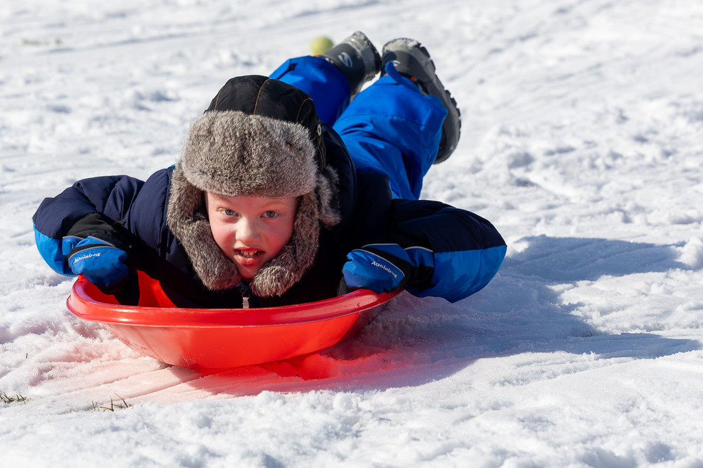Kids playing in the snow and sledding