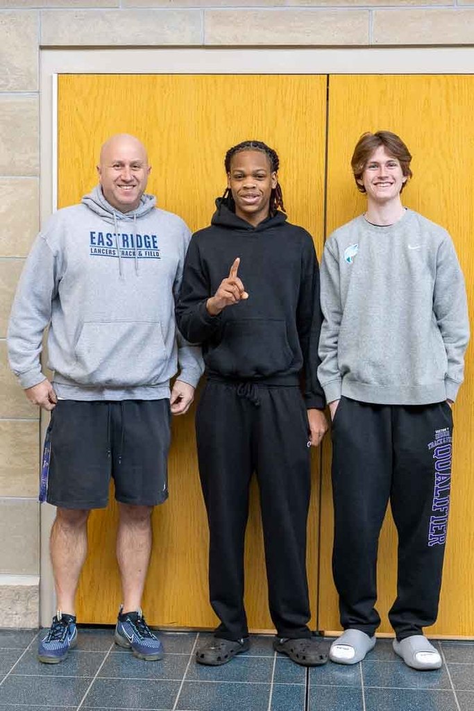 Students cheering on the athletes as they walk through the halls.