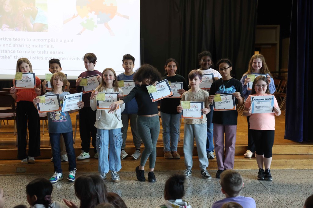 students hold up awards
