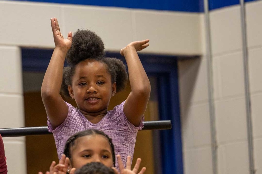 students singing and dancing at their concert