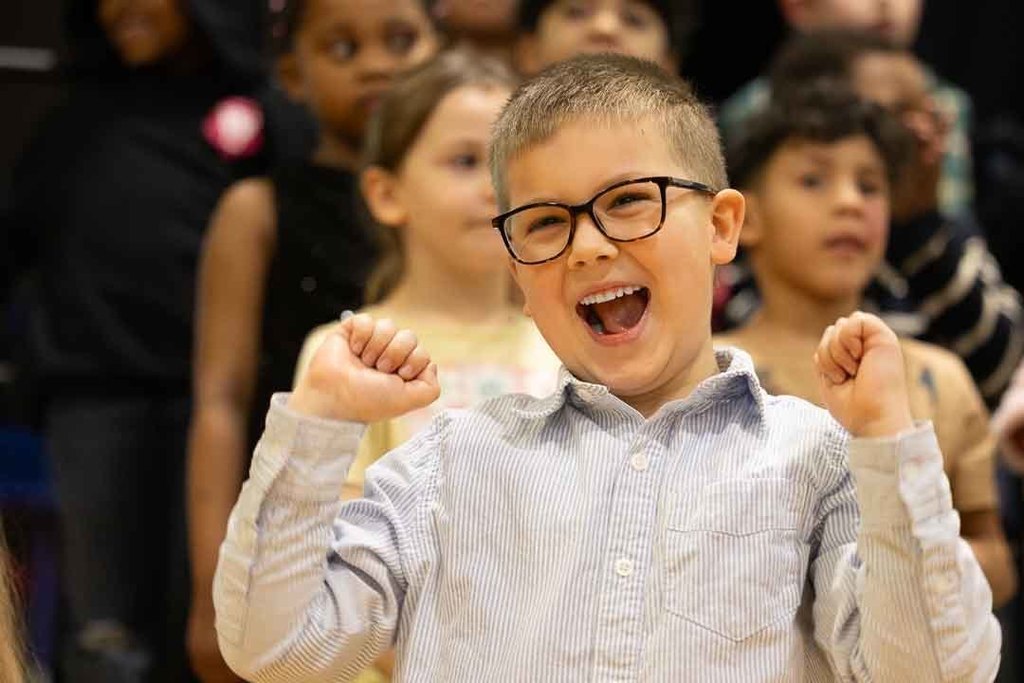 students singing and dancing at their concert