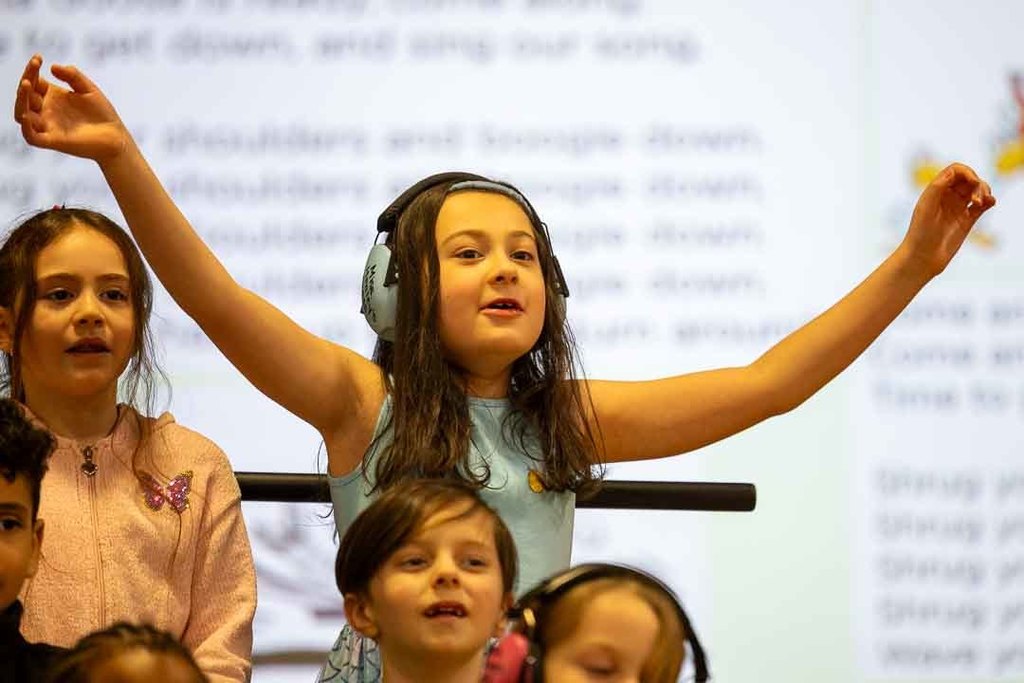 students singing and dancing at their concert