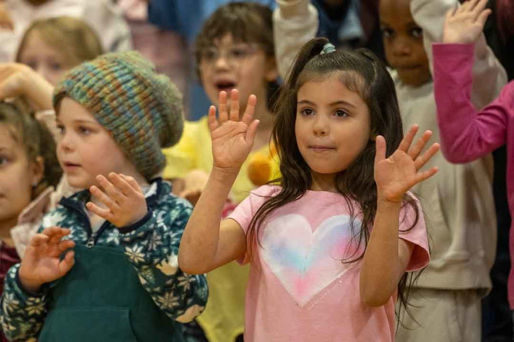 students singing and dancing at their concert