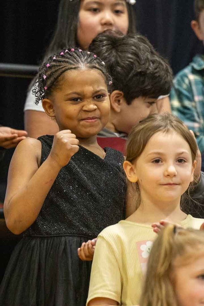 students singing and dancing at their concert