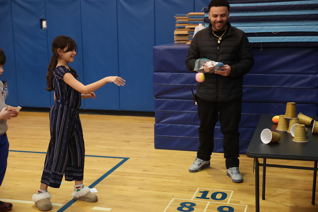 Student throws ball at cups 