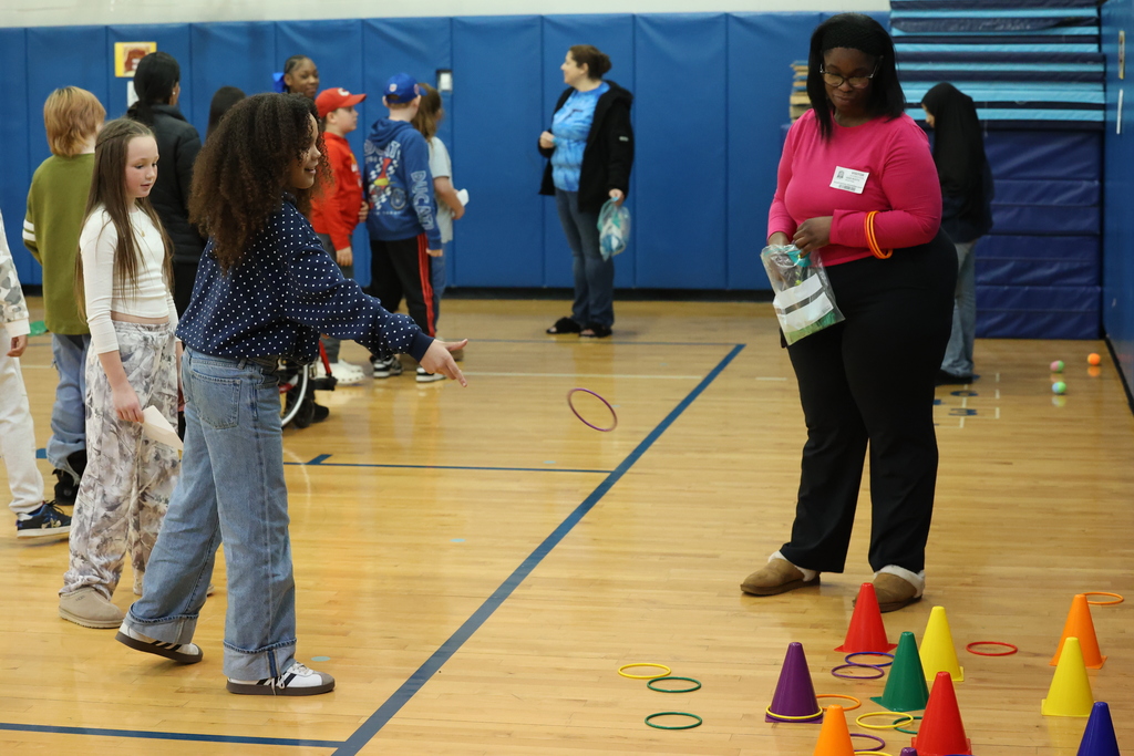 students throw colorful rings on colorful cones