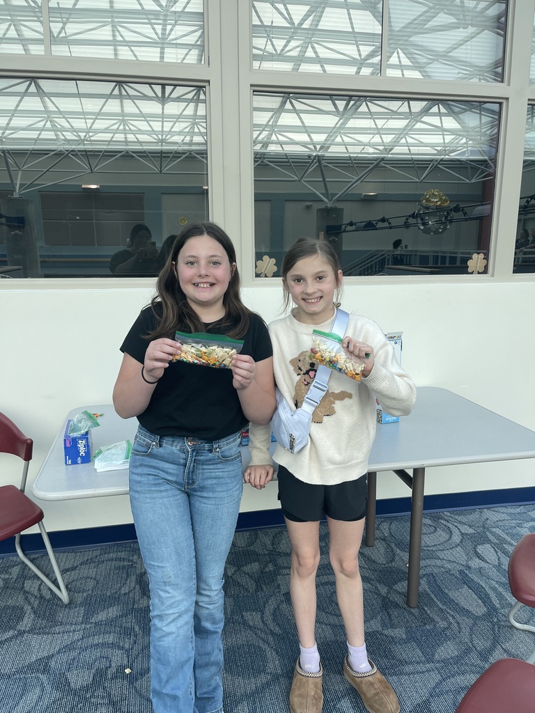 Students hold up bags of treats during Spring into Literacy Night