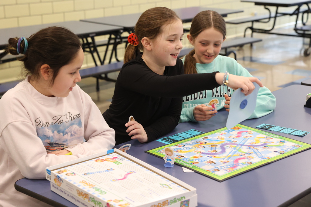 Students play chutes and ladders 