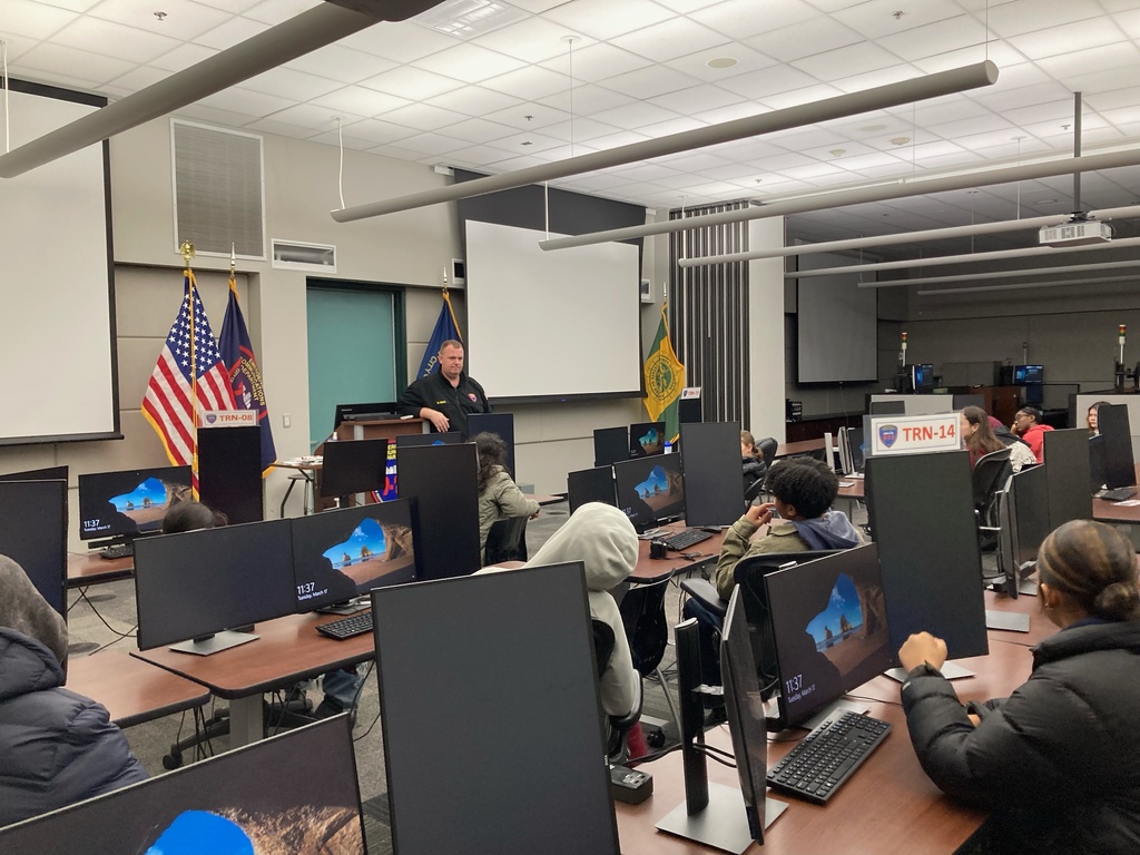 Students sit at desks and listen to presenter from the Monroe County’s Public Safety Department