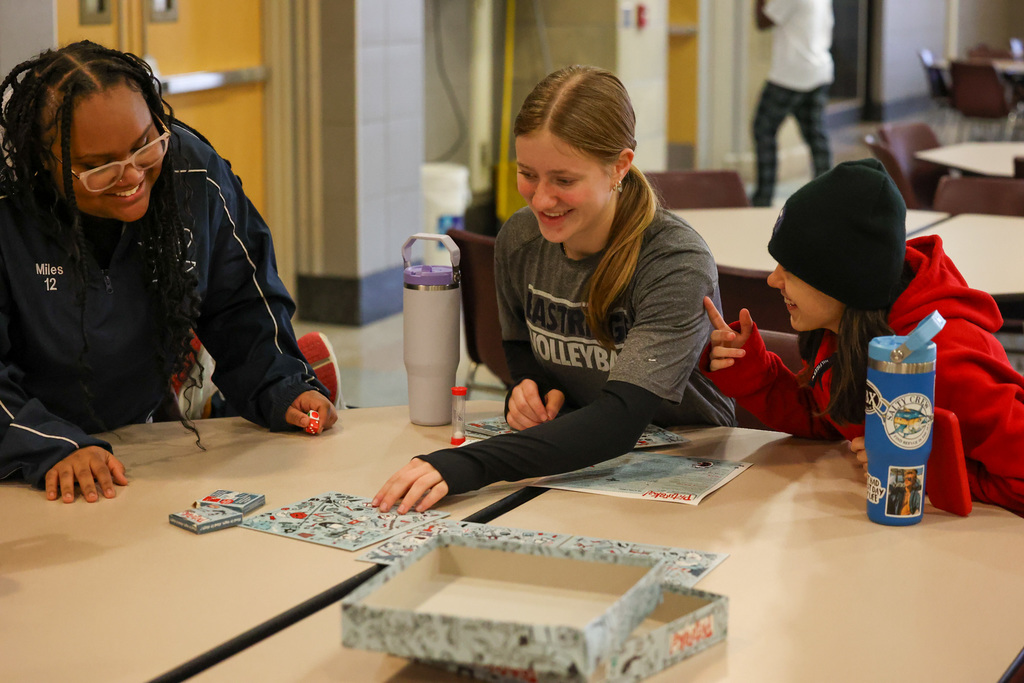 students play board game and smile